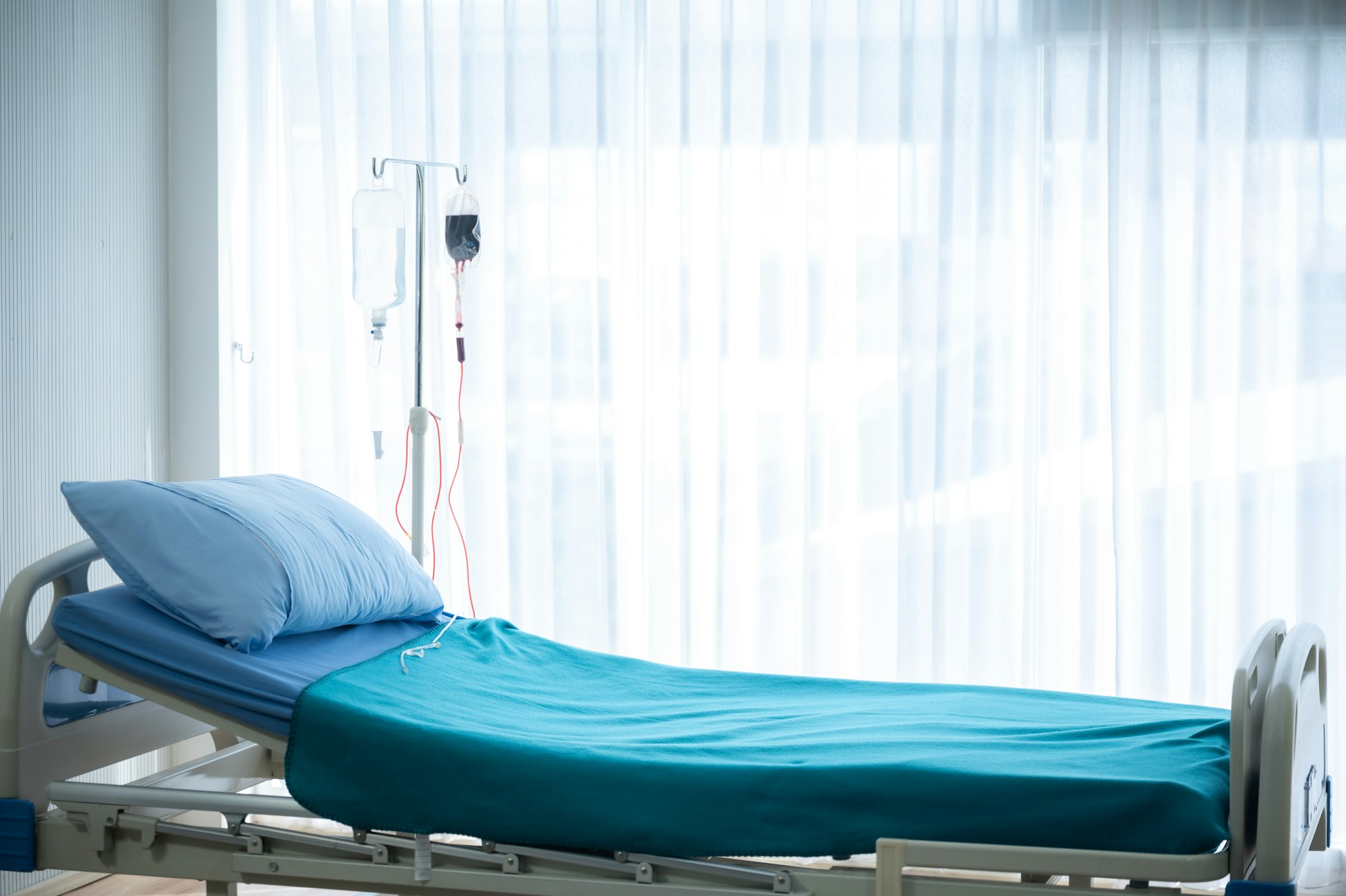 Empty hospital bed and room, concept of healing life insurance, patient recovery or death