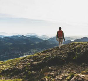 Austria, Salzkammergut, Hiker with backpack hiking in the Alps