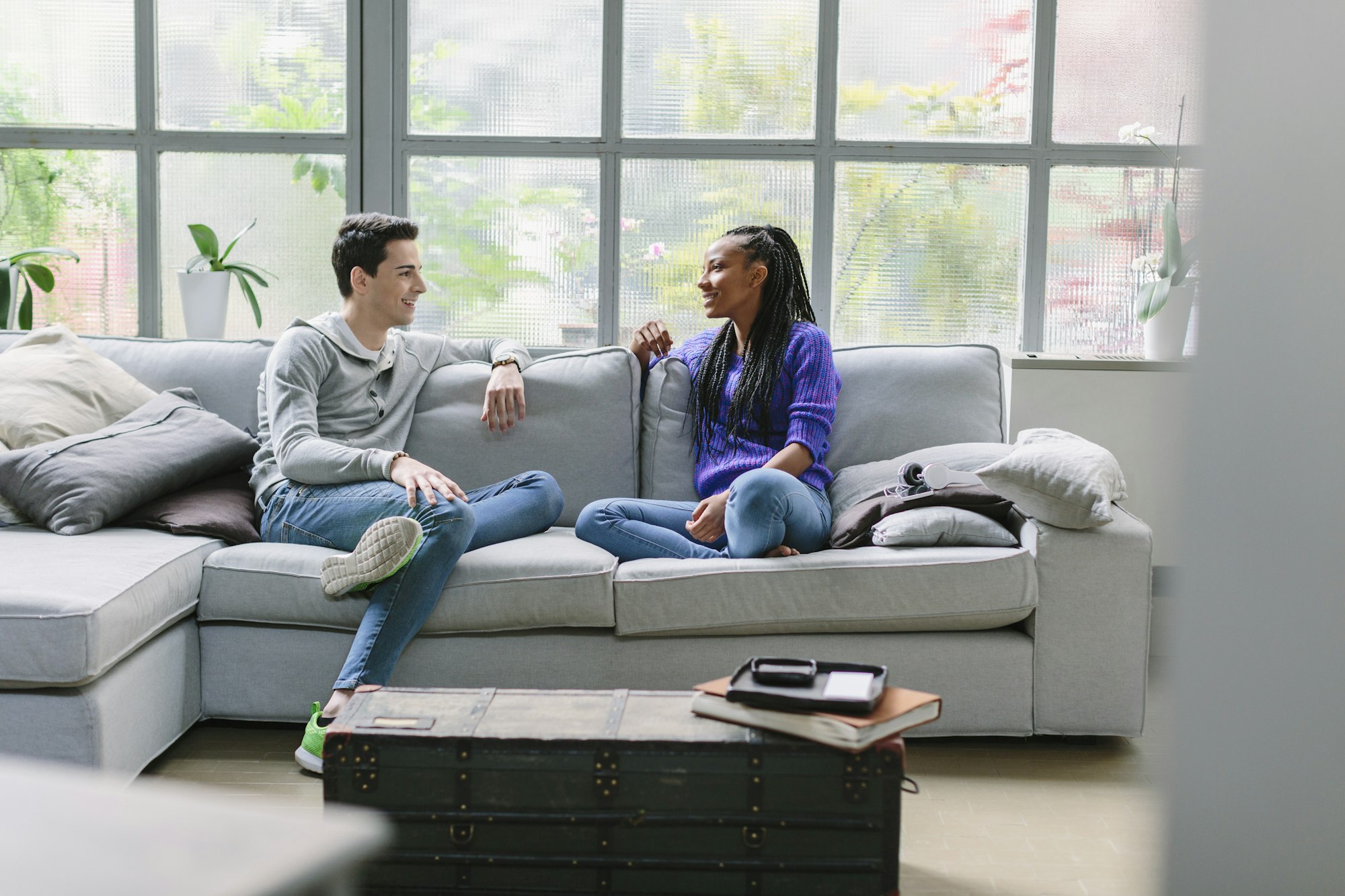 Couple sitting on sofa talking