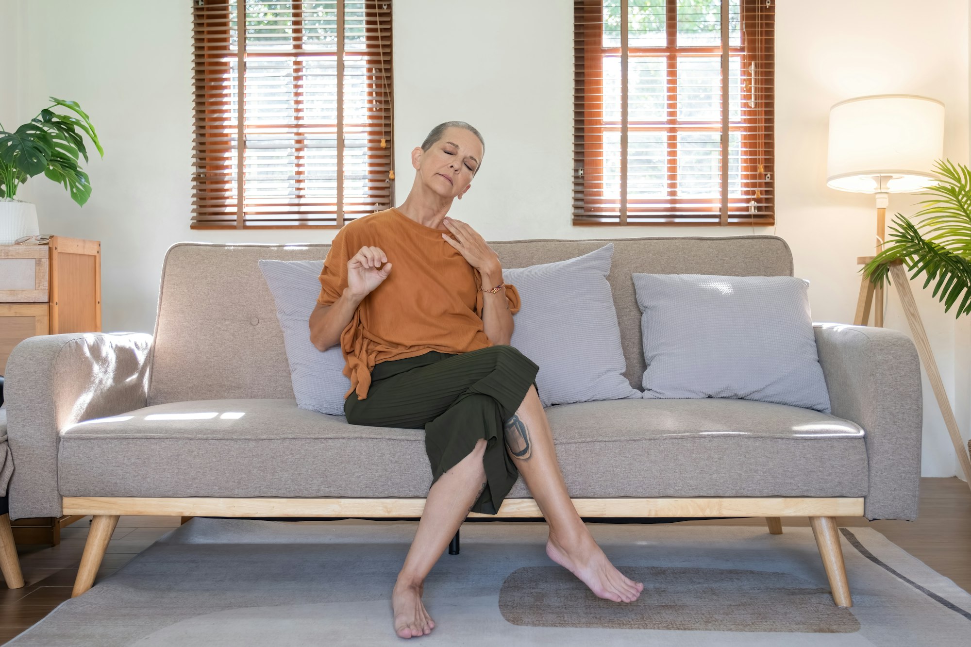 Elderly Woman Taking Care of Her Health at Home, Practicing Mindfulness and Relaxation on a