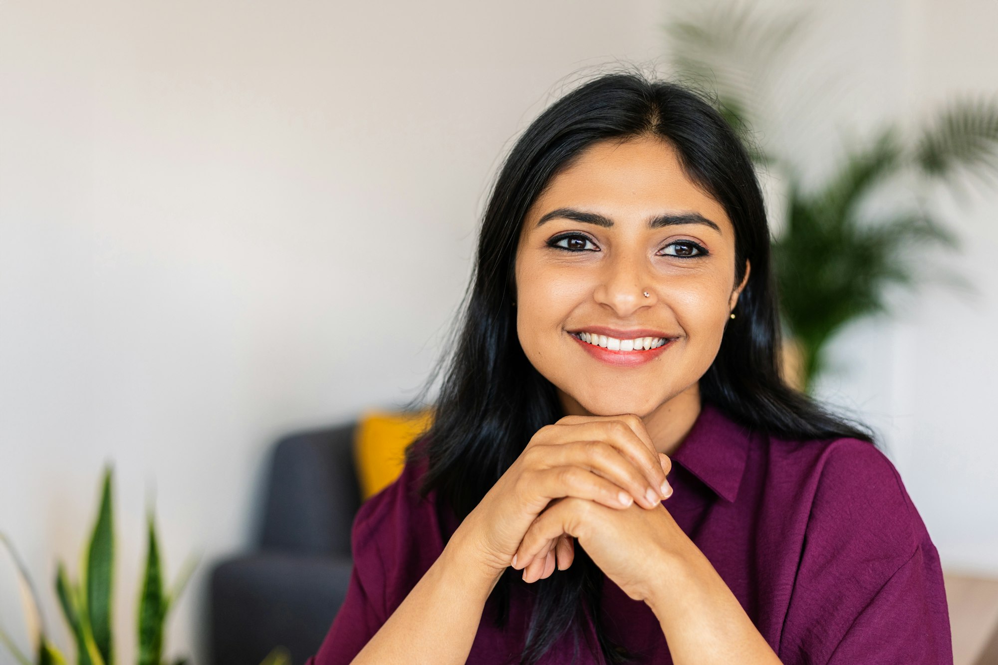 Young indian business woman looking at window thinking about new personal goals