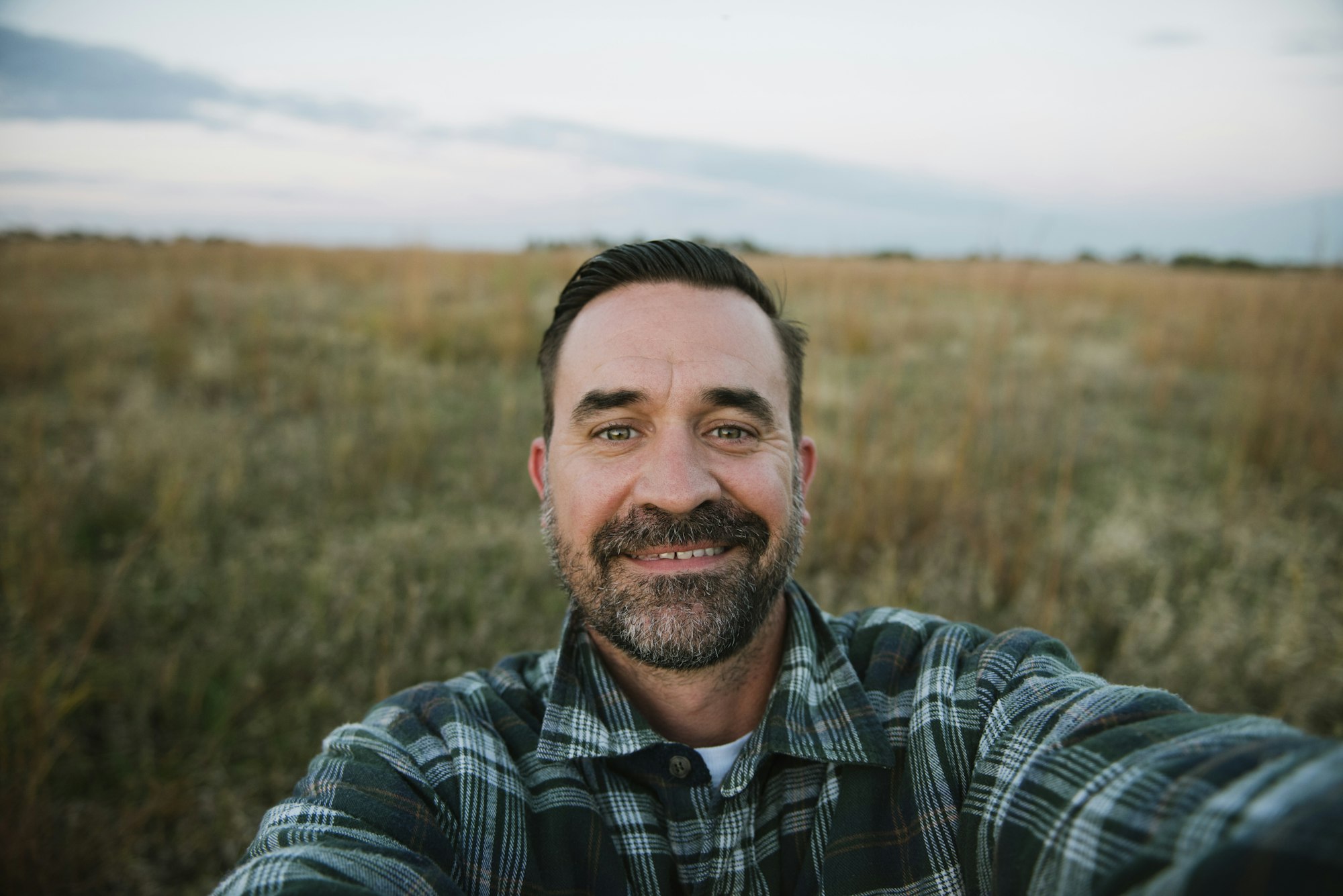 Self portrait of smiling farmer in field, Plattsburg, Missouri, USA