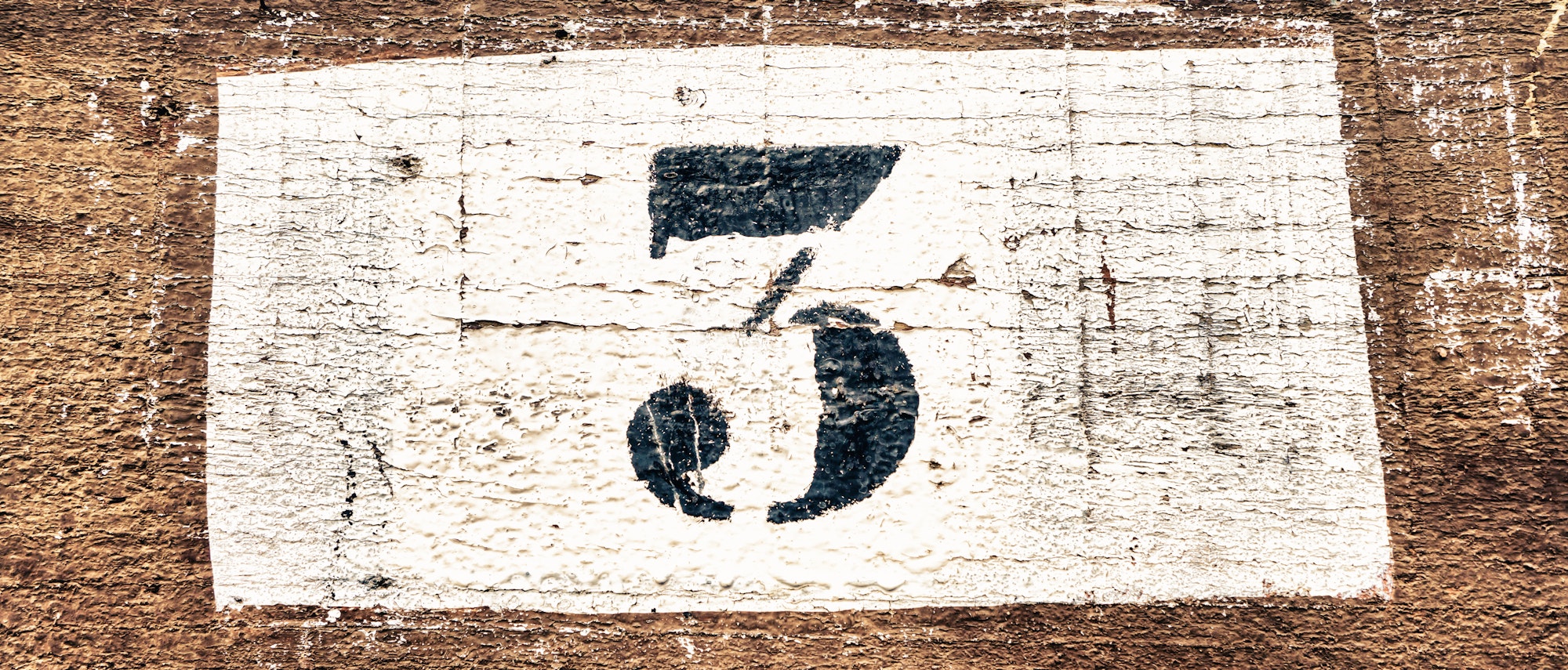 Closeup shot of number the 3 on a wooden background