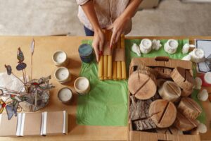 Close up of woman is packing handmade candles for selling in own home decor studio