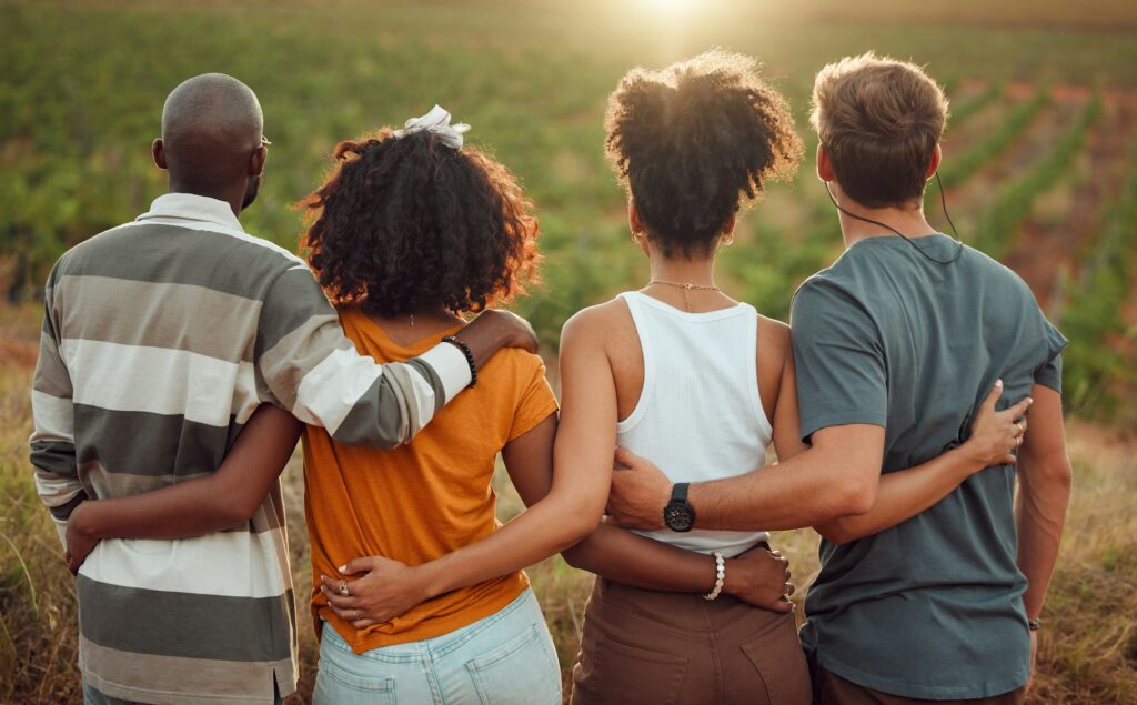 Diversity, friends and together hug, friendship and love on a countryside farm in France. People re