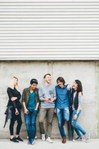 Group of multiethnic friends millennials using smartphone