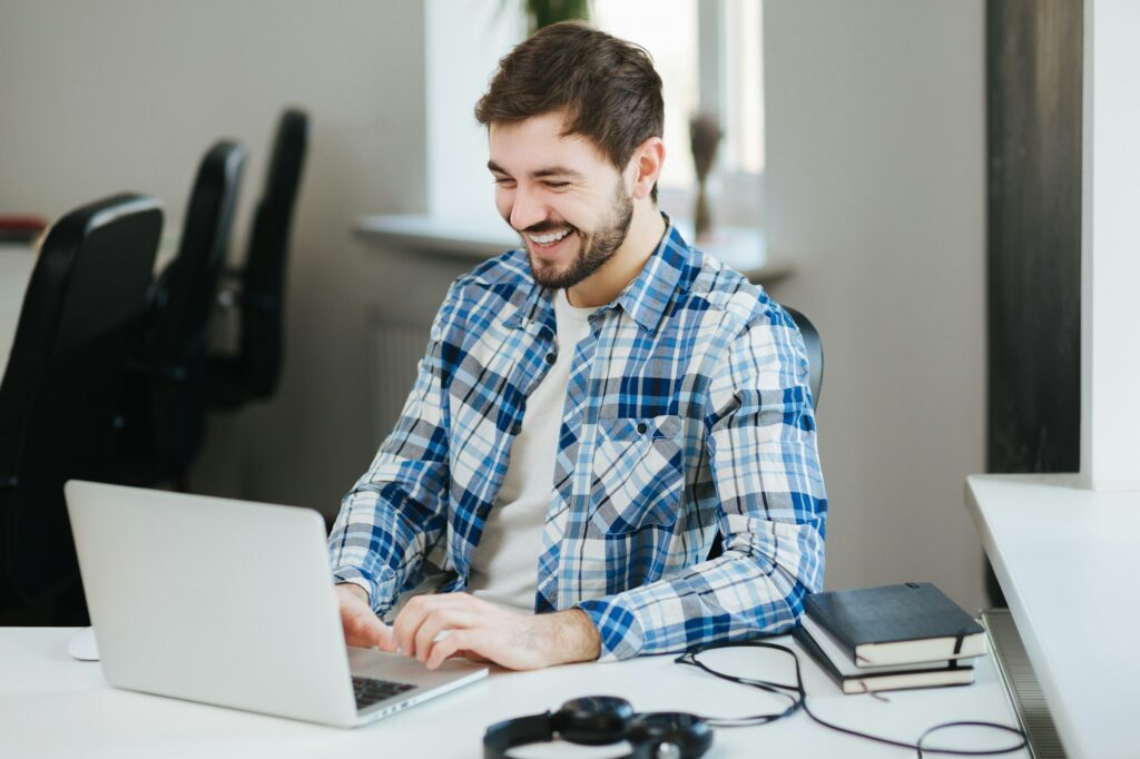 Happy man working on laptop