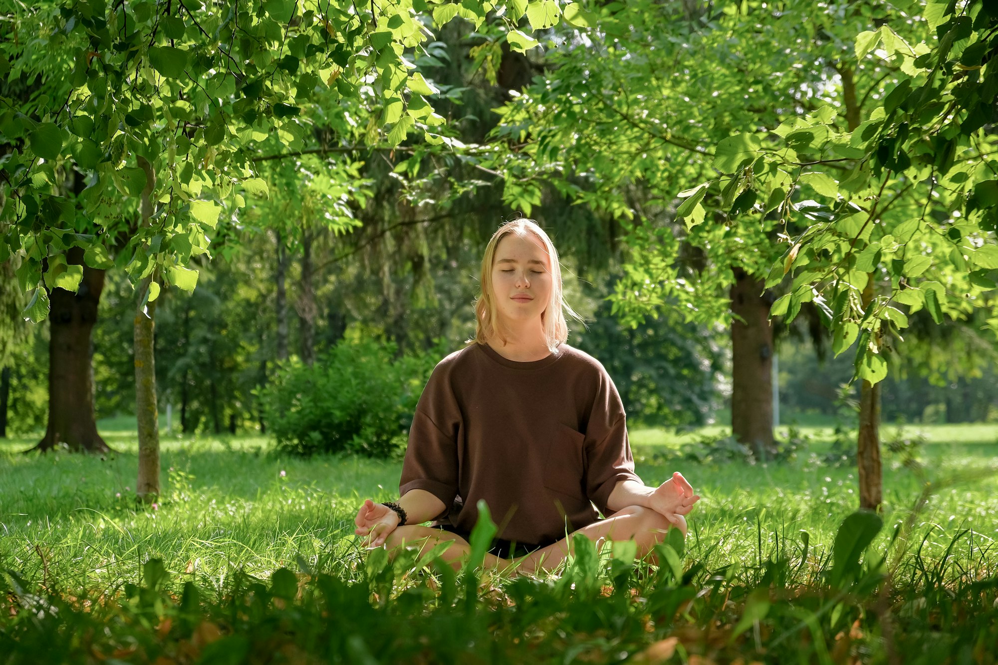 meditation Woman meditates in nature outdoor.At ground level, a relaxed woman meditates and breathes