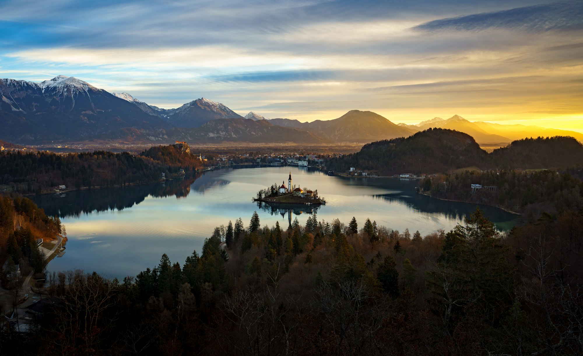 Aerial view of Lake Bled and Julian Alps with Church of the Assumption of Maria at sunrise, Slovenia