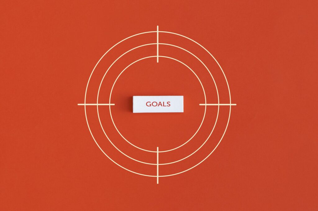 Goal word in the center of the target on red background.