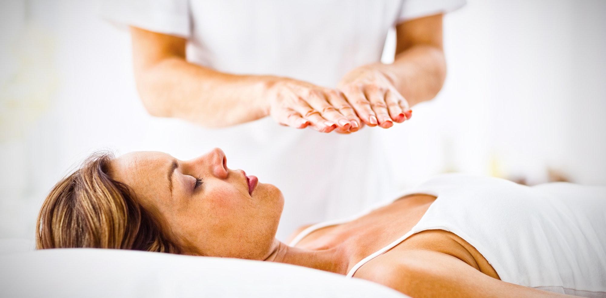 Young woman receiving reiki treatment